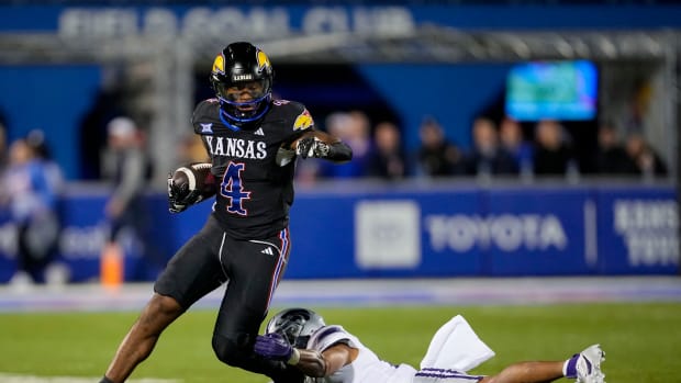 Nov 18, 2023; Lawrence, Kansas, USA; Kansas Jayhawks running back Devin Neal (4) runs the ball against Kansas State Wildcats safety Marques Sigle (21) during the first half at David Booth Kansas Memorial Stadium. 